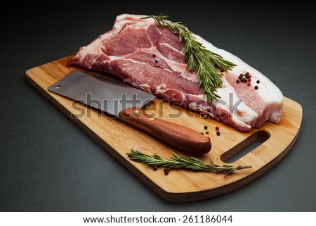 Meat pork fresh. Raw meat on cutting board. Rosemary spice and meat. Axe and meat pig. Fat piece