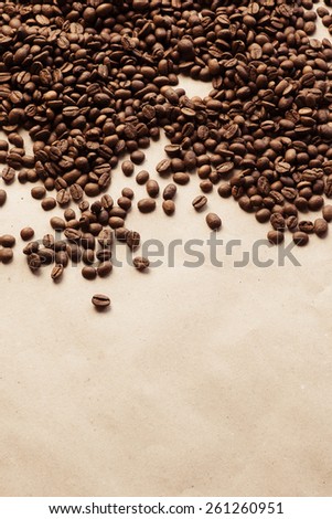 Coffee beans on paper background. Paper texture coffee. Dark coffee roasted. Arabica