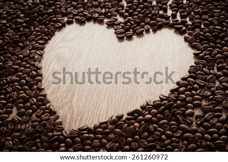 Coffee beans heart on wood background. Wood texture coffee. Dark coffee roasted. Coffee heart. Valentines day