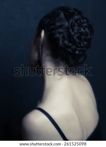 Neck of a woman. Lady\'s back. Brunette girl. Portrait tress woman. Back of the head. Hairdo, hairstyle. Strap