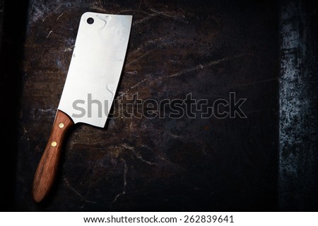 Kitchen ax, knife, cleaver, cutter with wooden handle. Axe on dark background. Ax for meat. Vintage