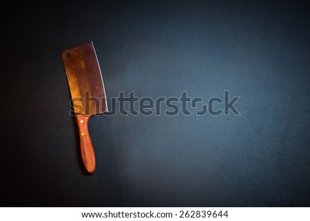 Kitchen ax, knife, cleaver, cutter with wooden handle. Axe on dark background. Vintage