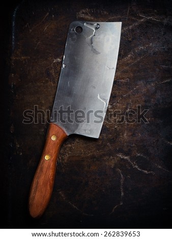 Kitchen ax, knife, cleaver, cutter with wooden handle. Axe on dark background. Ax for meat. Vintage