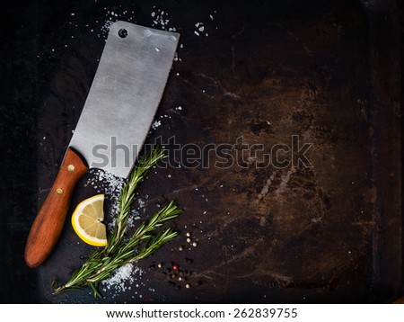 Kitchen ax, knife, cleaver, cutter with wooden handle. Axe on dark background with spices. Ax for meat. Vintage
