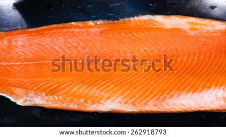 Fresh raw salmon on tray. Big cut piece raw salmon. Fish on tray. Fresh fish