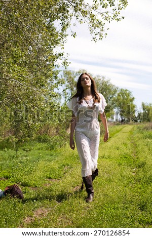 country woman in spring summer day. Spring mood. Summer wind. Fashion style model. Flowers spring. Lady in boots