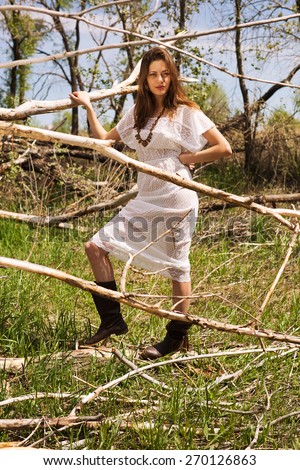 country woman in spring summer day. Spring mood. Summer wind. Fashion style model. Flowers spring. Lady in boots