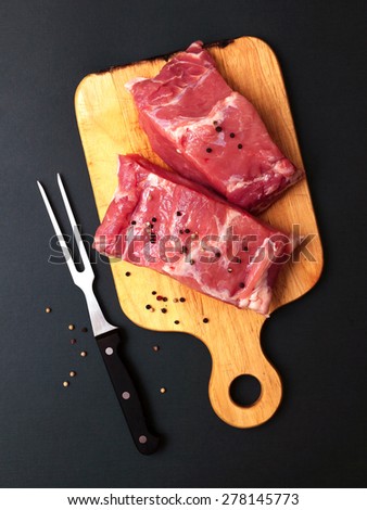 fresh pork meat on a dark background