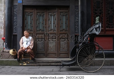 Chengdu, China - September 23, 2014. Drag carts man waiting for customer at Jinli Old Street in Chengdu.