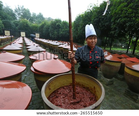 Pixian, Chengdu, Sichuan, China. September 24, 2015. Sichuan Spicy food, Chilli bean sauce is stirred up at the Sichuan Cuisine Museum. (Chilli bean sauce, Meticulously Brewed Douban, or Doubanjiang).