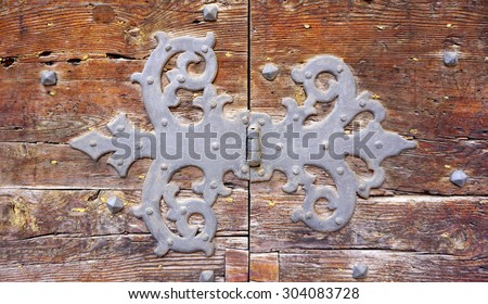 door hinge fitting art of old wooden door in Venice, Italy