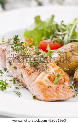 Salmon steak roasted with Salad and potato