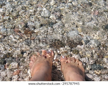 Soak feet in the water. Location - Garda Lake in Italy.