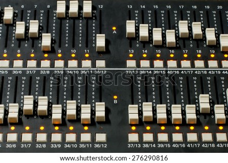 Close Up on a slide of a mixing console. It is used to control the Lighting for recording TV shows