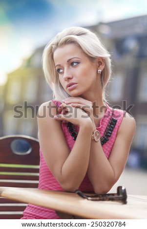 Young woman sitting under sun in old church