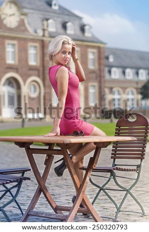 Young woman sitting under sun in old church