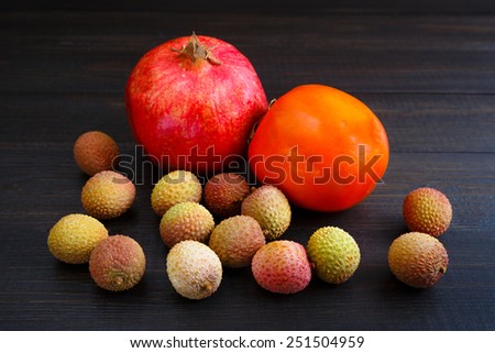 Delicious fruit set of persimmon, pomegranate and lychee