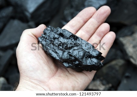 coal in a hand, a pit, mining operations, mining