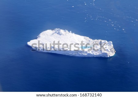 Iceberg with supraglacial pond float in Disko Bay, Greenland - An iceberg is a large piece of freshwater ice that has broken off a glacier or an ice shelf and is floating freely in open water.