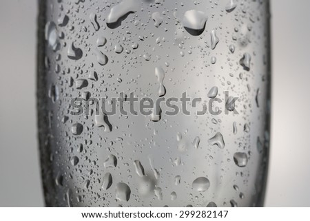 Water drops on cool empty champagne wine glass in black and whit
