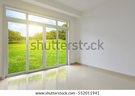 interior of new apartment, wide room with window, tiled floor