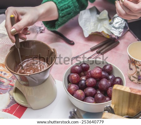 Melting chocolate to warm candles, cooking process chocolate fondue with fruit