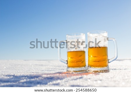 mug of cold beer in the snow