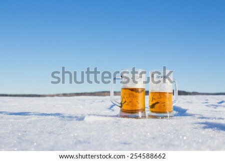 mug of cold beer in the snow