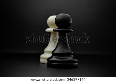 Chess. Black and White pawns on the black background. Pawns, infantry chess.