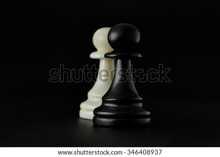 Chess. Black and White pawns on the black background. Pawns, infantry chess.