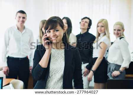 a group of people in business suits working in the office
