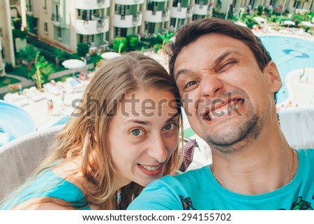 man and woman on the background of the hotel and the sea