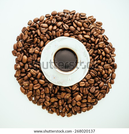 Coffee cup and circle from Grains, disk from coffee beans on a white background. Grains star are scattered on isolate background