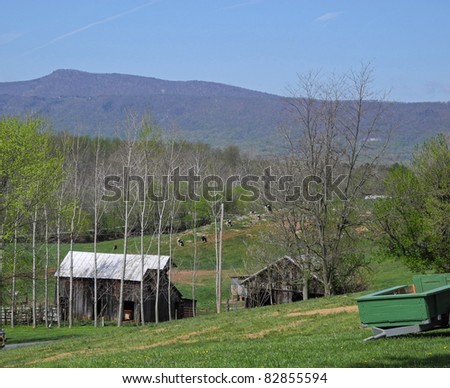A peaceful farm scene with rolling hills at the onset of spring, paints a charming view of the rural American landscape.
