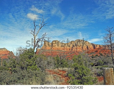 The rugged landscape around scenic Sedona, Arizona, offers lush trees and brush and dramatic, red-rock mesas, cliffs and monuments.