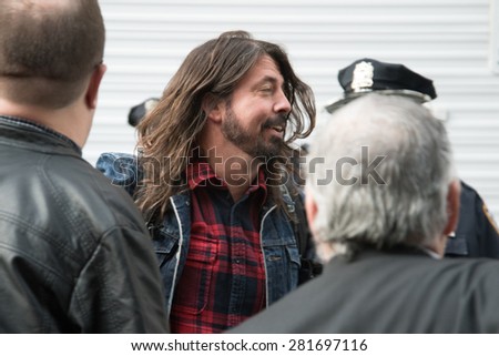 New York, NY / USA - May 20, 2015: David Grohl of Foo Fighters makes his way to his limo outside the Ed Sullivan Theater after his performance on the final episode of Late Night With David Letterman.