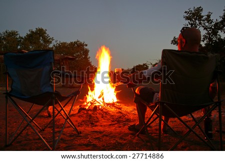 Sitting by the fire having a sundowner at the Savute Campsite