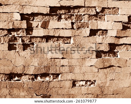 Sepia Brick Wall background\
\
The old half-ruined brick wall, plaster cracked and in places broke away. The impression is made that all finishing will shortly fail down