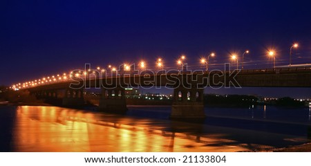 The night bridge with a number of beautiful lanterns and reflection in water