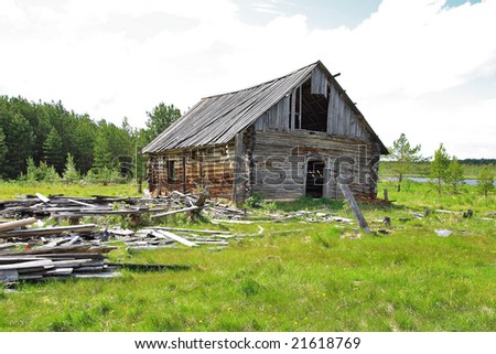 Sad landscape a-collapsing old log hut in the Siberian tundra
