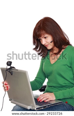 The businesswoman communicates through the Internet, looks in a web-cam