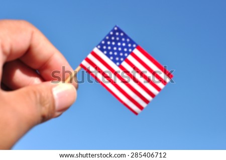 independence day usa - de focused usa flag in blue sky patriotic background
