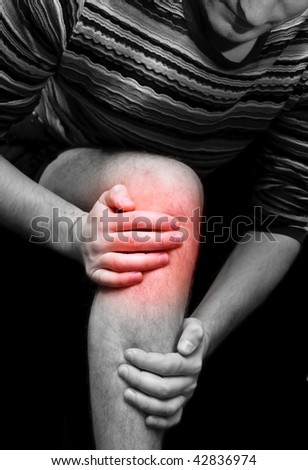 Young man having knee ache