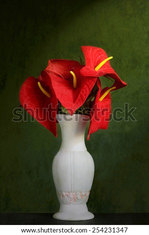 Red Flowers in a Vase on a wooden table