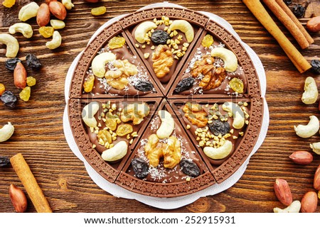 Handmade chocolate pizza with raisins and nuts