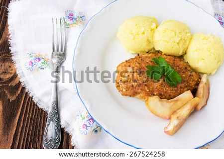 Baked chicken cutlet with apples, selective focus