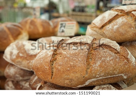 Crusty  fresh bread on sale at a market stall.