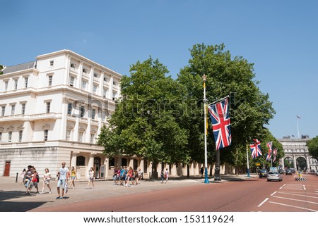 LONDON, ENGLAND - JULY 19: The Mall with union jack flag on July 19,2013. The Mall is a road in London running from Buckingham Palace at its western end to Admiralty Arch and on to Trafalgar Square.