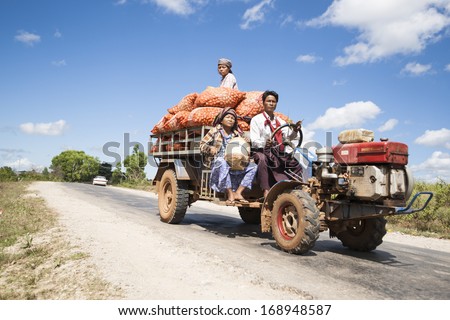 Bagan, Myanmar - November 1;Workers Sit On Top Of Sacks Of Potatoes On Back Of Small Truck On Way To Market In Bagan, Myanmar In November 1, 2013.
