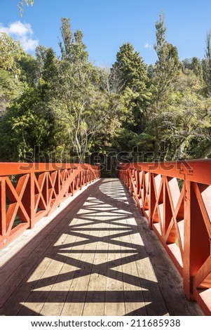 Criss-cross bridge railings and shadow patterns with diminishing perspective.